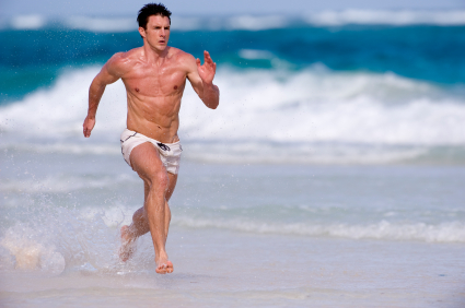 Young man running on the beach